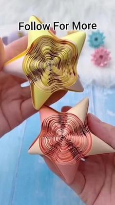 two star shaped brooches are being held in their hands