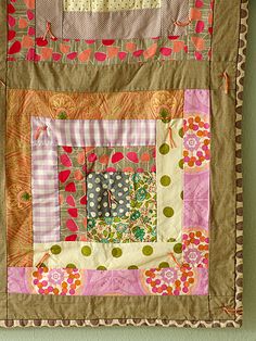 a patchwork wall hanging on the wall