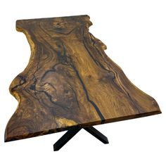 a wooden table with black metal legs and a piece of wood on it's side