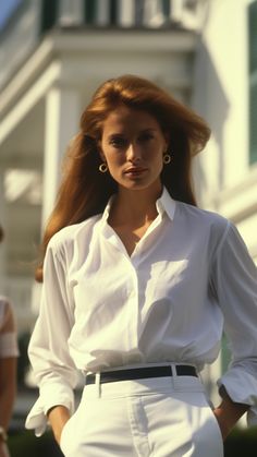 a woman with long red hair wearing white clothes