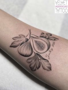 a close up of a person's arm with a flower tattoo design on it