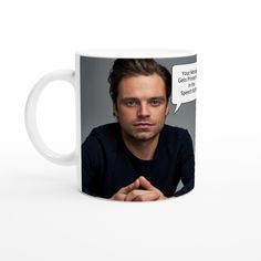 a white coffee mug with a man's face and speech bubble on the side