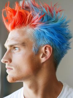 The Vibrant Dyed Mohawk turns heads with its bold color choices—think electric blues, fiery reds, or even pastel hues. It’s perfect for the creative soul attending art shows or music festivals, where self-expression is celebrated. Best suited for those with round or oval faces, this style pairs well with playful eye colors like green or blue. Dyed Mohawk, Dreadlock Mohawk, Taper Fade Mohawk, Mohawk Hairstyles For Men, Warrior Braid, Braided Designs, Punk Spikes, Long Mohawk, Punk Mohawk