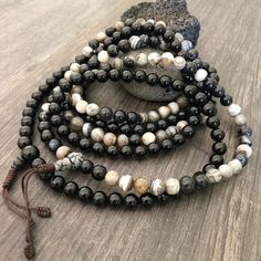 Beautiful black and mix Agate Japa Mala from Nepal. You can choose between the Black Agate mala and the Mix Agate mala necklace. A unique praying mala that can be used as a necklace or as an ornament. The mala has no clasp, you wear it over the head. The mala necklace is 42.5cm- 16.75 inch long A most have addition to your jewelry collect To see more unique Mala necklaces click the link below https://www.etsy.com/shop/AkashiJewelry?ref=seller-platform-mcnav&section_id=18307945 Enjoy Con salu Black Agate Necklace, Buddhist Mala, Wiccan Necklace, Tigers Eye Necklace, 108 Mala Beads, 108 Bead, Skull Necklace, Black Agate, Mala Necklace