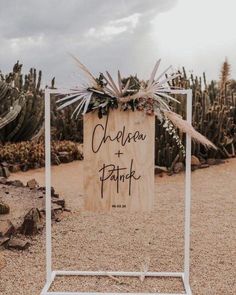 a wooden sign that says chelcen and patrick on it in front of cactus plants