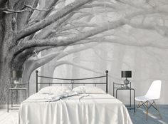 the bedroom is decorated in white and has a large tree mural on it's wall