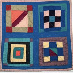 a quilted wall hanging with squares and rectangles