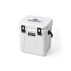 a white yeti cooler with the letter n on it's lid and black handles