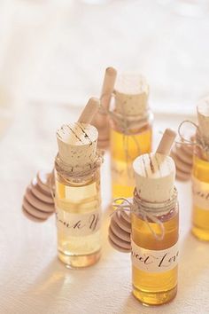 honey jars filled with bees sitting on top of a table