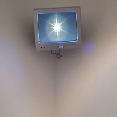 a television mounted to the side of a wall in a room with no one around it