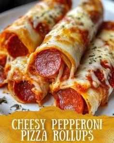 two pepperoni pizza rolls on a plate with the words cheesy pepperoni pizza rolls