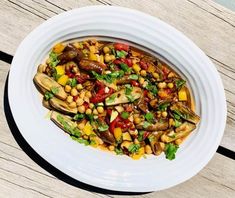 a white plate topped with food on top of a wooden table