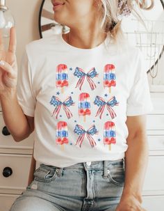 4th of July popsicle shirt, patriotic shirt, Independence Day shirt, American flag, 4th summer shirt, America shirt, USA vintage shirt  My shirts, sweatshirts, and tanks are a fun and joyous way to show your style while shopping, heading to the beach, and bringing your children to social events, family outings, and everyday life. All my t-shirt designs are direct to garment and provide the best quality and longevity.  Vintage Strawberry Floral Picture:  Cottage core floral design Sizes: S - 2XL Summer Americana Style Short Sleeve T-shirt, Summer Flag Print Short Sleeve Tops, Patriotic American Flag Print T-shirt For Summer, Patriotic White Tops For Summer, White Patriotic Tops For Summer, White Patriotic Summer Tops, Patriotic American Flag Shirt For Independence Day, Patriotic Shirt With American Flag For Independence Day, Fun Cotton Shirt For Independence Day