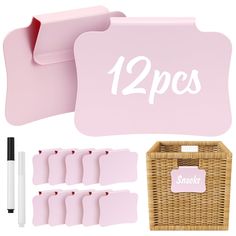 a set of pink placemats, pen and paper holders next to each other