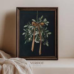 an image of a painting on the wall with a bow hanging from it's side