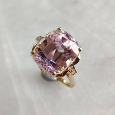 ITEM DESCRIPTION: >>The ring is made from Solid 14K Yellow Gold. Gemstone used is absolutely natural and ethically sourced.  >>Natural and AAA grade quality Kunzite is beautifully studded with Diamonds. >> This statement ring is a perfect adornment on a wedding and even delightful for an engagement. Gem: Kunzite Gem size: 12.5 x 10.75 mm Gem shape: Cushion Gem weight: 9.15 Carats Gem: Diamond Gem size: 1.20  mm Gem shape: Round Gem weight: 0.029 Carats (4 pieces) Gold purity: 14K (58.33% approx.) Gold weight: 3.25 grams  Total weight of stones : 9.18 cts Gross weight of ring: 5.09 grams The Gold purity is guaranteed and it comes with authentic 14K gold hallmark. Since these Rings are handmade, they are Nickel/Lead FREE.  CUSTOMISATION: >>Size Customization is available for this ring and it Luxury Kunzite Jewelry With Accent Stones, Yellow Gold Morganite Jewelry With Center Stone, Elegant Morganite Diamond Ring With Gemstone, Luxury Morganite Cushion Cut Jewelry, Luxury Cushion Cut Morganite Jewelry, Heirloom Morganite Jewelry In Yellow Gold, Yellow Gold Jewelry With Kunzite Gemstones, Morganite Fine Jewelry In Yellow Gold, Elegant Cushion Cut Yellow Gold Amethyst Ring