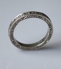 Quite the prettiest ring from the early 1900s. Sterling silver band with a width of 2.5mm, and set with marcasites inset along the length of the ring. The sides of the ring are engraved with a scroll design, giving it the attention at all angles - sideways and face on. Weight is 2.7g Ring size: US: 6  UK: L 1/2 Heirloom Engraved Round Band Rings, Vintage Oval Engraved Diamond Ring, Classic Engraved Ring With Decorative Band For Promise, Vintage Sterling Silver Jewelry With Decorative Band, Antique Silver Rings For Anniversary, Heirloom Ring With Intricate Round Band Design, Heirloom Ring With Intricate Design, Silver Stackable Anniversary Rings With Single Cut Diamonds, Heirloom Stackable Rings With Decorative Band