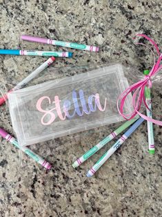 a clear bag filled with pink and green crayons sitting on top of a counter