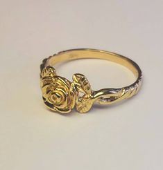 You are looking at a beautiful 14 carat yellow gold rose ring with leaves The ring is all hand carved paying close attention to detail One rose means love at 1st sight Can be ordered in white gold, yellow gold, rose gold, and platinum Can be ordered in sizes 4 to 9 Comes in a beautiful Box Money back guarantee Rose Ring Gold, Fine Jewelry Rose Design Flower Ring For Promise, Fine Jewelry Flower Ring With Rose Design For Promise, Elegant Rose Detail Rings For Anniversary, Rose Design Flower Ring For Promise, Elegant Promise Ring With Roses Detail, Gold Flower Ring With Rose Design For Wedding, Gold Rose Ring, Wedding Gold Flower Ring With Rose Design