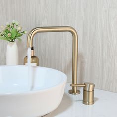 a bathroom sink with a faucet and soap dispenser