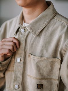 This denim shirt is a year-round essential for your wardrobe. It can be worn alone in the summer or as a layering piece in the colder months. Vintage-inspired work-shirt detailing. Crafted from heavyweight cotton with a straight fit, it is a washed out taupe. FEATURES 100%cotton Straight collar Buttoned placket Two chest pockets. SIZING & FIT Please carefully read the size info before purchase! Different products have different size info.Please use this info as a general guide as measurements ar Brown Cotton Shirt With Patch Pockets, Brown Everyday Collared Shirt, Brown Cotton Utility Top, Everyday Cotton Button-up Denim Jacket, Relaxed Fit Beige Cotton Denim Jacket, Beige Relaxed Fit Cotton Denim Jacket, Everyday Brown Cotton Shirt, Brown Button-up Shirt For Everyday, Brown Button-up Everyday Shirt