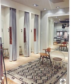 a room with chairs and rugs in it