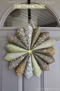 a paper wreath hanging on the front door