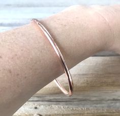 "This listing is for ONE bangle. Create your own set by choosing your size and number of bangles at checkout. Each bangle is approximately 1/8\" wide and is made from solid copper. They have been soldered into a complete circle, sanded, and polished to sparkle. There is a small solder seam. The bangles slide over your hand onto your wrists. To measure, we suggest you touch your thumb to your pinkie, then measure the circumference of your knuckles in that position. We will use this measurement fo Adjustable Hoop Bangle For Everyday, Handmade Adjustable Hoop Bracelets, Adjustable Stackable Hoop Bangle, Minimalist Hoop Bangle As Gift, Rose Gold Hoop Bracelets For Gift, The Bangles, Curling Ribbon, How To Clean Metal, Clear Nails