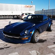 a blue sports car parked in a parking lot