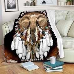 an elephant with feathers on it's head is sitting in front of a couch