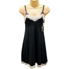 Get Ready To Turn Heads With This Stunning Marilyn Monroe Black Camisole. Made From A Polyester Blend, This Full Slip Features A Beautiful Lace Trim With A Double Row Of Lace Along The Bottom Hem, Giving It A Timeless Classic 50s Feel. The Adjustable Straps Make It Easy To Wear And Machine Washable For Convenience. Ideal For A Slip Or As Intimate Sleepwear, This Camisole Is Available In Size S And Is New With Tags. Size Small Measurements Are Approximate Pit To Pit 15 Under Bust 13.5 Length 26" Black Sleeveless Sleepwear With Lace Trim, Fitted Night Sleepwear With Contrast Lace, Black Sleepwear For Sleepovers, Black Coquette Sleepwear For Sleepover, Coquette Black Sleepwear For Sleepover, Black Lace Nightgown With Lace Trim, Black Nightgown For Sleepover, Black Coquette Nightgown For Sleep, Coquette Black Nightgown For Sleep