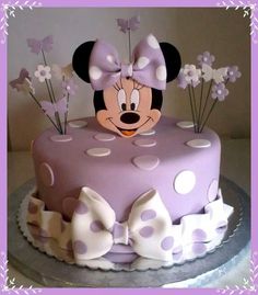 a minnie mouse cake with polka dots and bows