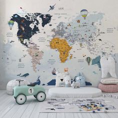 a child's bedroom with a map wallpaper and toy cars