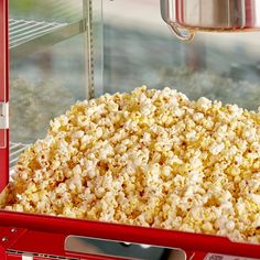 popcorn is being made in a red machine