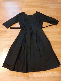 "Mid Century Womens Black Rayon Satin Taffeta Special Occasion Dress Size S Very Good Vintage Condition, No Rips Or Tears, Deodorant Residue Mainly Inside Under Arms. Will Need To Be Cleaned. Dress Has Been Hemmed Up And Could Be Let Down For A More Authentic 40s Length. No Labels Seen Fabric Appears To Be A Rayon Or Silk Satin Taffeta Beautiful Fabric, Not Sure Photos Give Justice Rounded/Boat Neckline 7 Covered Buttons In Front For Decor Closure Is Small Black Snaps And 1 Hook At Waist Raglan 1950s Style Black Knee-length Dress, 1950s Style Black Cocktail Dress, Black 1950s Style Cocktail Dress, Vintage Full Skirt Evening Dress, Retro Black Vintage Dress For Evening, Black Knee-length Vintage Dress For Evening, Retro Black Dress With Full Skirt, Black Retro Dress With Full Skirt, Black Knee-length Vintage Evening Dress