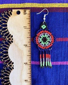 These chaquira beaded earrings make the perfect colorful and joyful statement accessory for any outfit you choose! Select your earrings by the letter according to photos.**Listing is for 1 pair of earrings only**All items are made with love by talented skilled artisans. Because of the handmade nature of the items, they may have some imperfections. However, this is what makes them one of a kind! Artisan Multicolor Round Beaded Earrings, Artisan Multicolor Beaded Earrings For Gift, Unique Multicolor Beaded Earrings As Gift, Colorful Round Beads Earrings As Gift, Multicolor Round Bead Earrings For Gifts, Multicolor Dangling Beads Earrings For Gift, Multicolor Beaded Drop Earrings As Gift, Multicolor Tiny Beads Earrings For Gift, Multicolor Beaded Drop Earrings For Gift