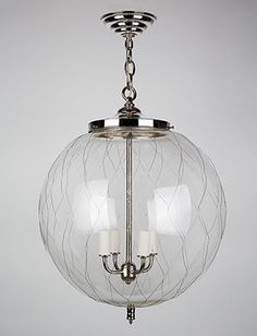 a glass globe light hanging from the ceiling