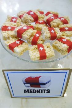 red and white desserts are displayed on a glass platter with a sign that says med kits