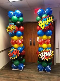 an office decorated with balloons and boom signs for the entrance to a conference room at work