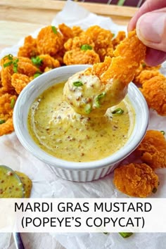 a person dipping some food into a bowl with the words, mardi gras mustard pope's copycat