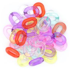 a pile of colorful plastic objects on a white surface