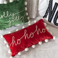 three pillows with pom - poms on them and the word hello spelled in cursive writing