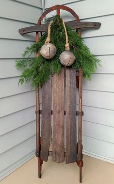 an old sled with ornaments hanging from it