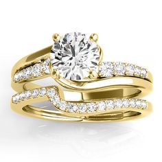 a yellow gold wedding ring set with two matching bands and a round diamond center stone