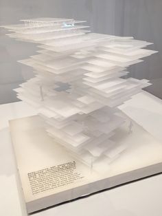 a book with an upside down design on it's cover and pages stacked in the air