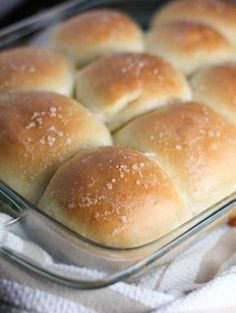 a glass baking dish filled with bread rolls