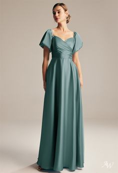 a woman in a long green dress