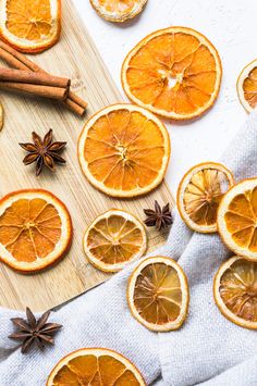 sliced oranges and cinnamon on a cutting board next to anisette, star anise