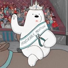 a cartoon bear with a ribbon around its neck and crown on his head in front of an audience