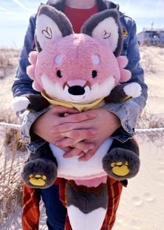 a person holding a stuffed animal in their arms